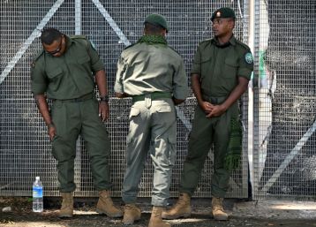 Members of the Solomons International Assistance Force stand guard at the entrance of a vote counting centre in Honiara