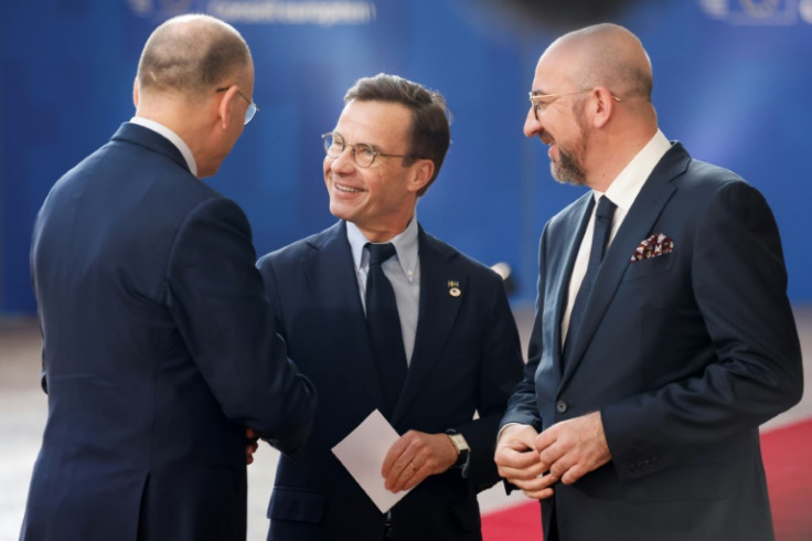 Former Italian premier Enrico Letta, left, presented a report to EU leaders during the summit in Brussels