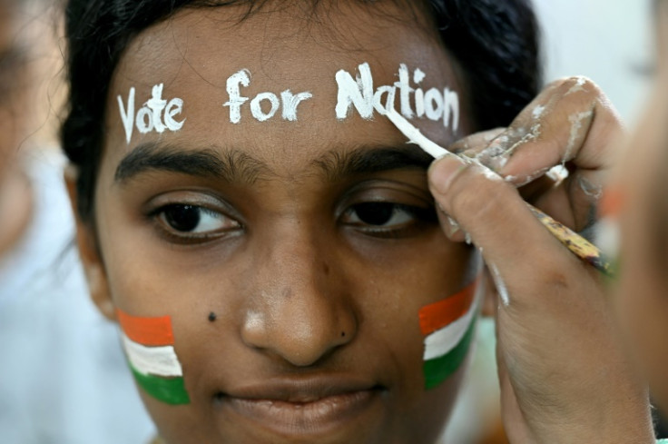 India begins six weeks of voting on Friday in general elections; in this photograph from Mumbai, an art school student encourages people to take part