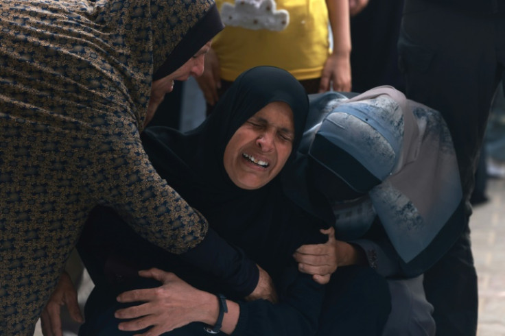 Palestinians mourn over the bodies of relatives killed during Israeli bombardment in Rafah