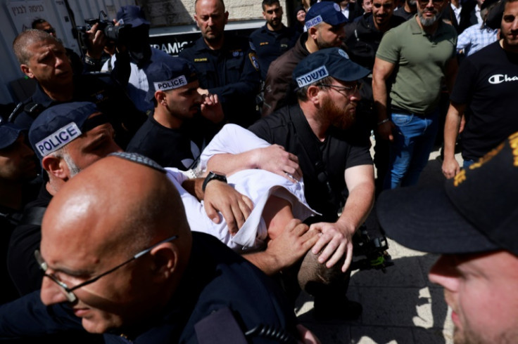 Israeli police detain a man at the site of a reported ramming attack in Jerusalem