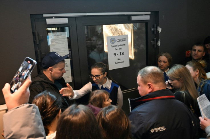 An employee of the passport office talking with Ukrainians who had gathered