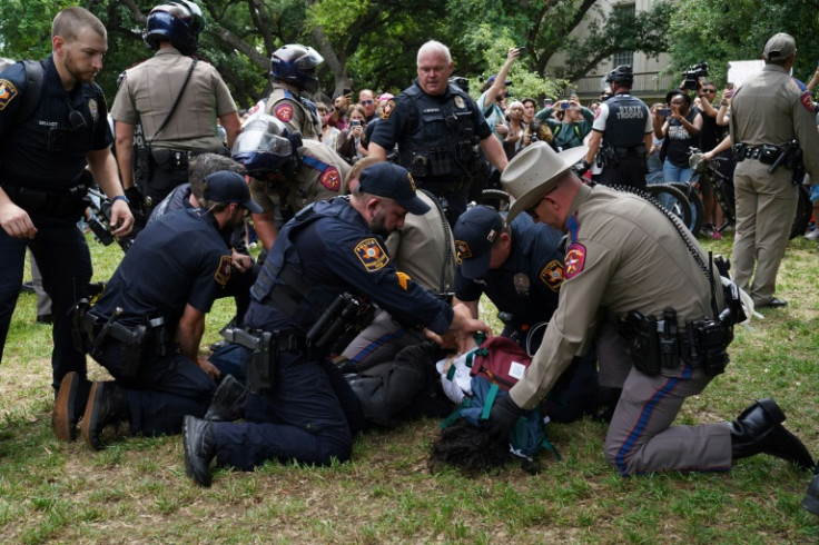 A person is detained by police at the University of Texas, as the protests in solidarity with Palestinians spread across US campuses