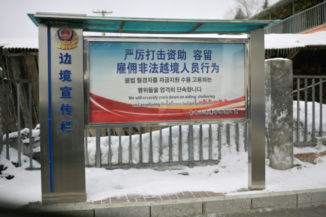 A police sign warns against helping illegal cross-border migrants in Changbai in China's northeastern province of Jilin