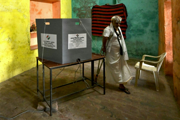 A Hindu holy man casts his ballot at a polling station on Friday in Vrindavan