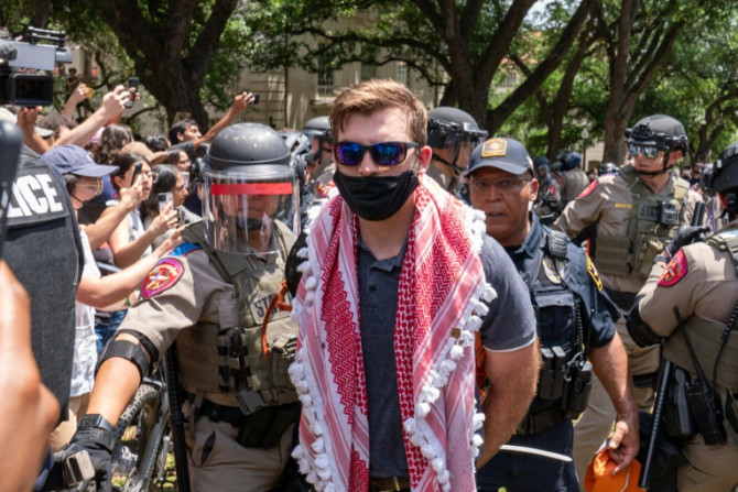 A pro-Palestinian protestor is arrested by Texas State Troopers at the University of Texas in Austin