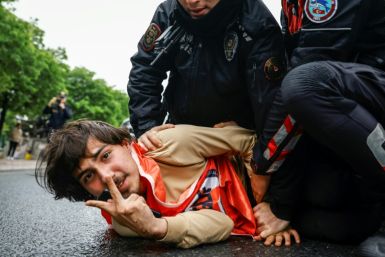 Turkish police detain a protester as he and others attempt to march to Taksim Square,