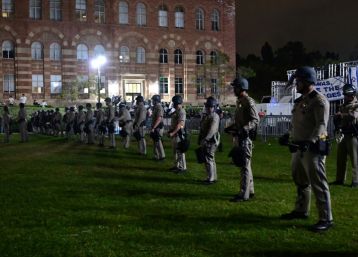 US police officers stand guard after clashes erupted on the campus of the University of California Los Angeles (UCLA)