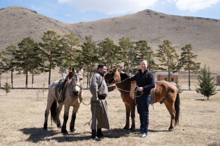Cameron (R) has visited 33 countries, including Mongolia, in his six months as UK foreign secretary