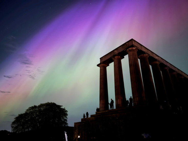 This handout photo taken and released by Jacob Anderson shows the northern lights, or aurora borealis, during a solar storm over the National Monument of Scotland in Edinburgh