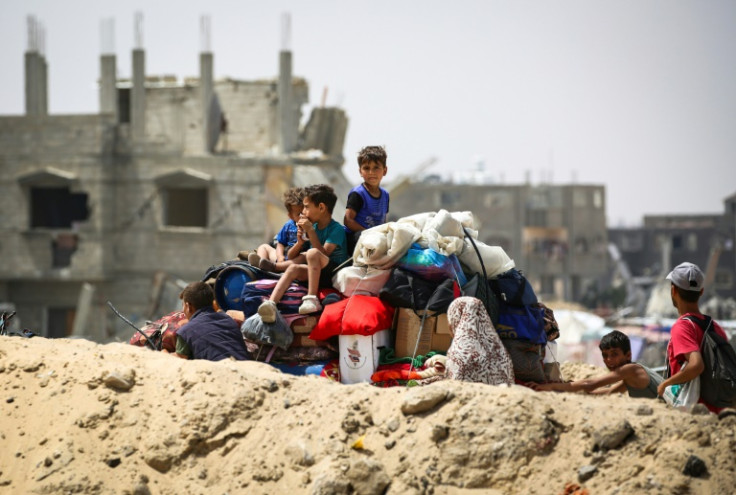 Palestinians transporting their belongings arrive in Khan Yunis in the southern Gaza Strip to seek shelter