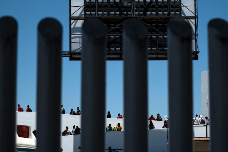 Asylum seekers walk to their appointments with US authorities at a border crossing seen from the Mexican city of Tijuana