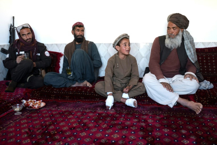 Sayed (2R) was still in bandages as he told AFP about the explosion in April that killed his younger brother