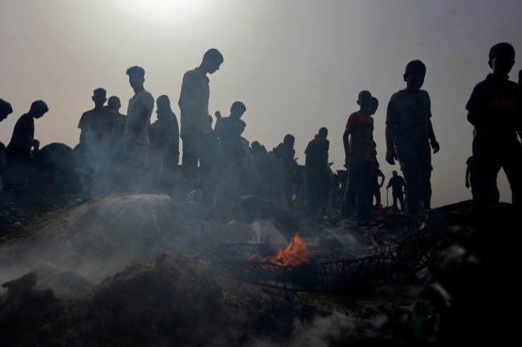 Palestinians gather at the site of a deadly Israeli strike at a camp for internally displaced people in Rafah