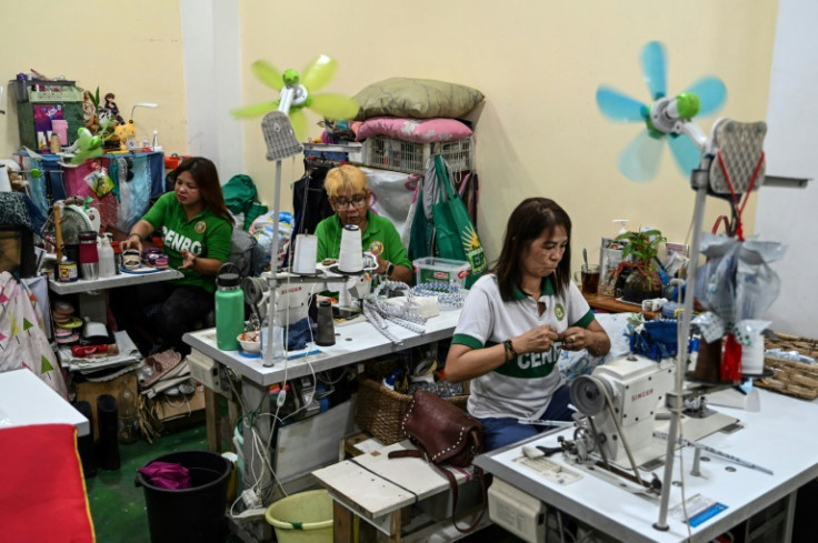 Government workers craft recovered plastic waste at a facility in Paranaque, Metro Manila
