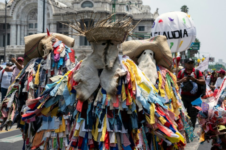 Supporters of ruling-party presidential candidate Claudia Sheinbaum wearing traditional costumes head to her campaign finale in Mexico City