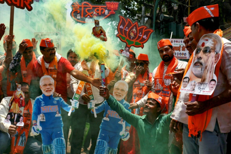 Supporters of Prime Minister Narendra Modi carry his cut out as they celebrate in Varanasi on June 4