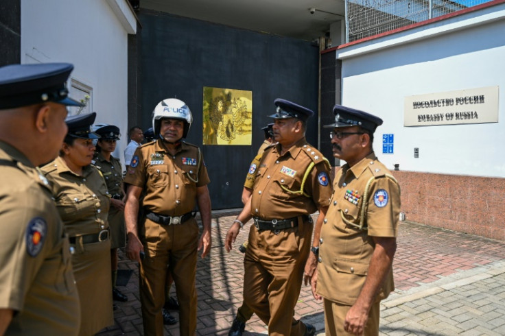 Police guard the Russian embassy in Colombo as a protest takes place nearby seeking the release of Sri Lankan ex-soldiers fighting in the Ukraine war