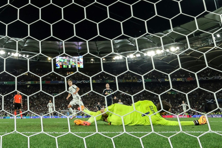 Hungary forward Kevin Csoboth (L) scores against Scotland