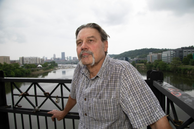 Edward Stankowski, Jr., a former steelworker, stands on the Hot Metal Bridge above the Monongahela River, a waterway once teeming with iron ore and coal barges for Pittsburgh steel mills