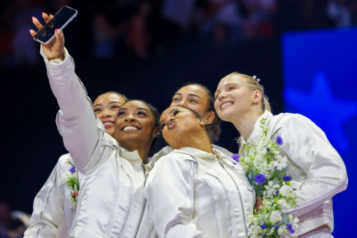 (L-R) US gymnasts Suni Lee, Simone Biles, Hezly Rivera, Jordan Chiles and Jade Carey pose for a selfie after being selected for the 2024 US Olympic gymnastics team at the US trials