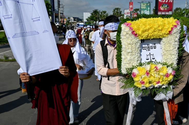 Ahead of the verdict the four activists and a few dozen supporters had marched to the court in a mock funeral procession, wearing white, a colour of mourning