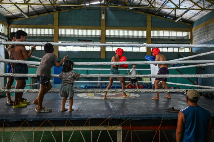 Young boxers train at the gym in Bago City under the buzz of old electric fans straining to give some relief from the oppressive tropical heat