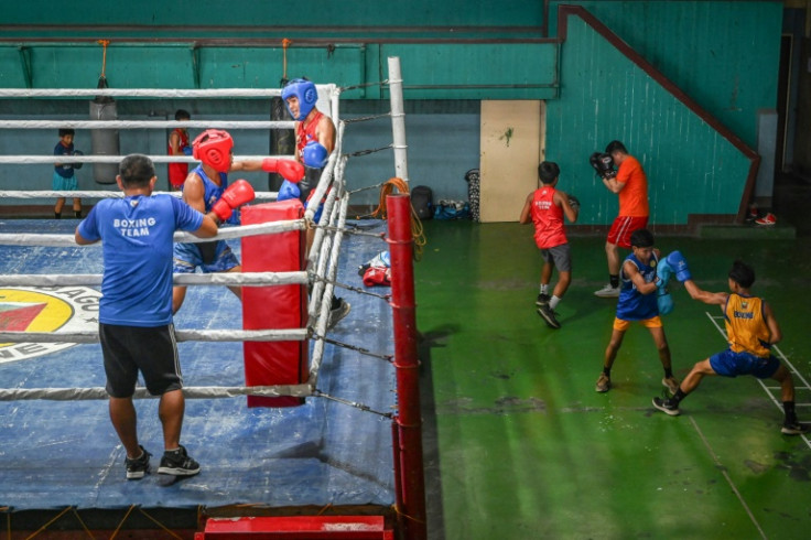 Young boxers go through their paces in the heat. "To them, if they excel in it they believe they will have a better life"