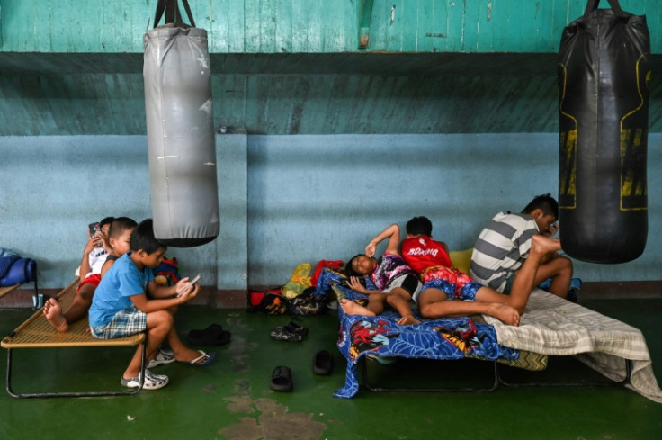 Young boxers rest at the gym in Bago City under peeling punching bags, some even sleep there at night
