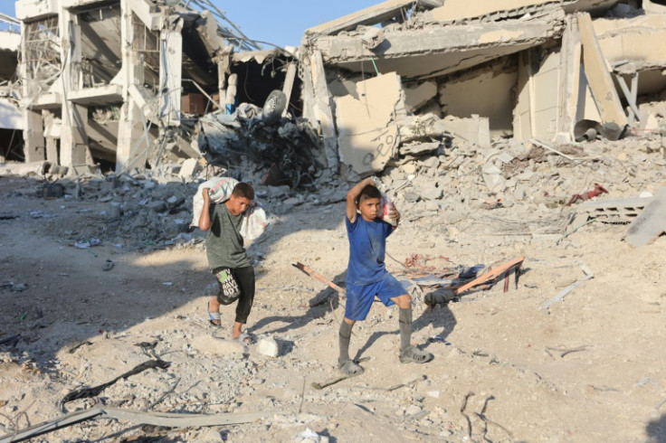 Palestinian boys carry sacks in Shujaiya -- the UN says Gaza's newly displaced have 'critical levels of need'