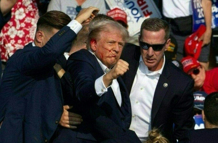 Republican candidate Donald Trump is seen with what appears to be blood on his face surrounded by secret service agents as he is taken off the stage at a campaign event at Butler Farm Show Inc. in Butler, Pennsylvania, July 13, 2024. Republican candidate