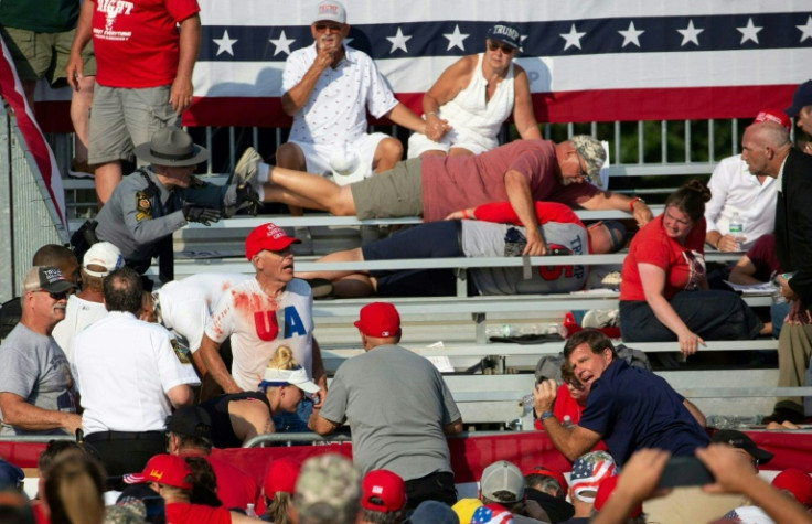 Trump supporters are seen covered with blood in the stands after guns were fired at Republican candidate Donald Trump at a campaign event