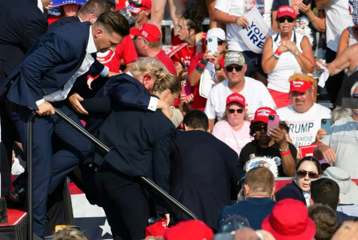 Republican candidate Donald Trump is seen with blood on his face surrounded by secret service agents