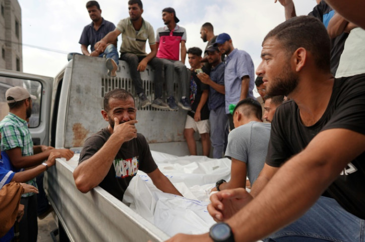 Mourners transport the bodies of members of the Qadih family to a burial ground in Khuzaa in the southern Gaza Strip, following an overnight Israeli strike that hit their house in Bani Suheila on Sunday