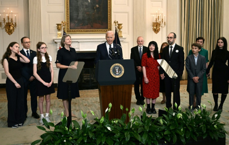 US President Joe Biden, standing alongside family members of the freed prisoners, speaks about the prisoner exchange with Russia, in the State Dining Room of the White House in Washington, DC, on August 1, 2024. Biden hailed the prisoner swap with Russia