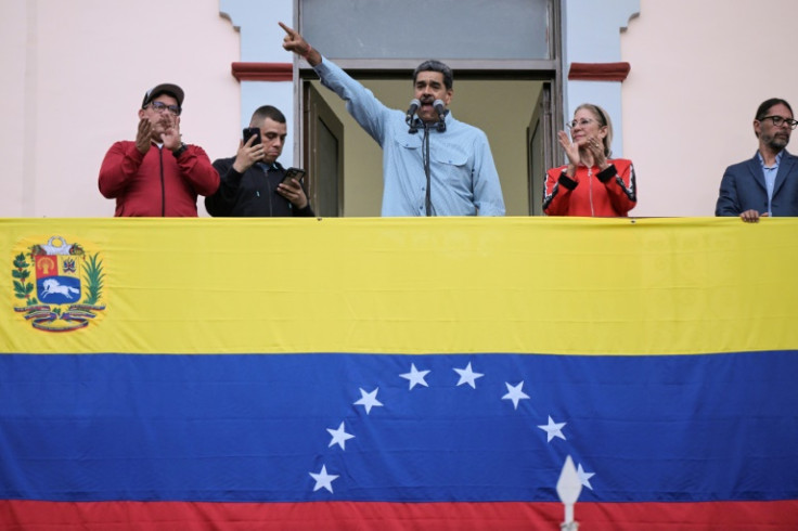 Venezuelan President Nicolas Maduro (C), accompanied by his wife Cilia Flores (C-R), delivers a speech to his supporters in Caracas on August 1, 2024