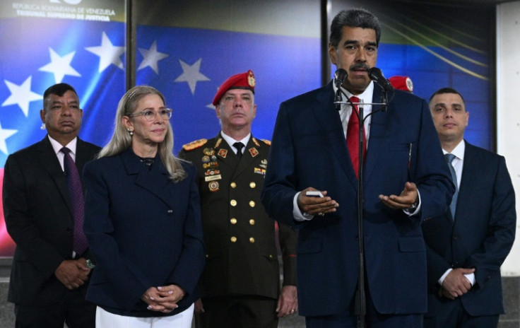 Venezuelan President Nicolas Maduro, accompanied by his wife Cilia Flores, speaks with the media at the Venezuela's Supreme Court of Justice