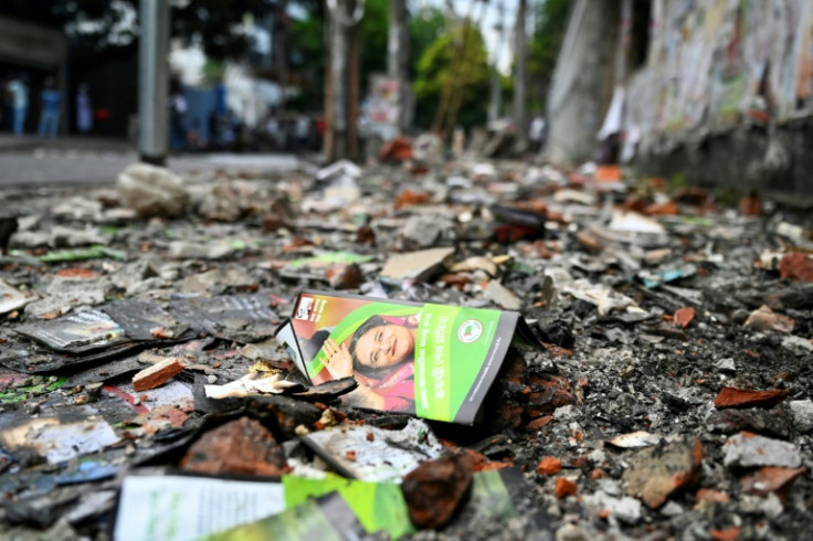 A burnt Awami League party office is pictured in Dhaka: police reporting mobs had launched revenge attacks on Hasina's allies