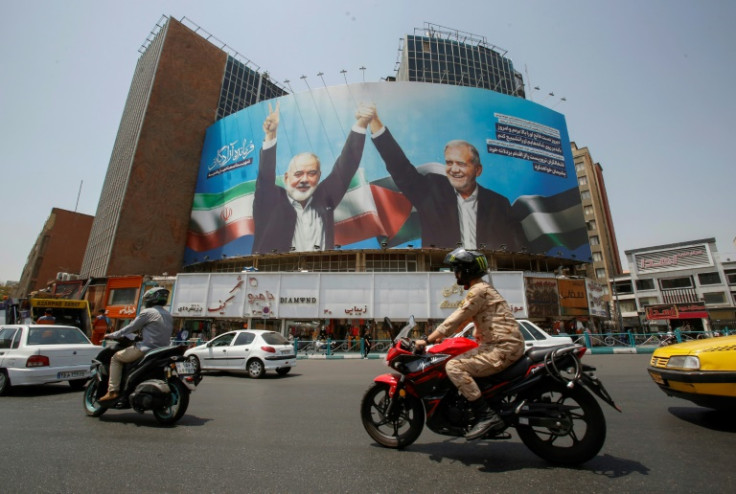 A billboard in Tehran depicting Iranian President Masoud Pezeshkian (R) and slain Hamas leader Ismail Haniyeh