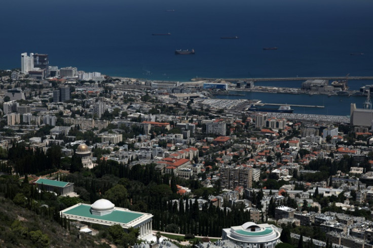 The city of some 280,000 people cascades down a steep hillside to the very edge of the port, leaving residents vulnerable to any explosion caused by Hezbollah bombardment