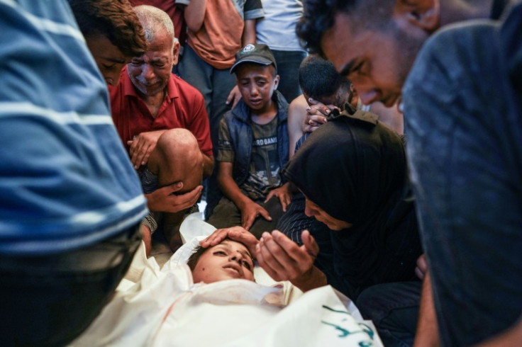 Palestinians mourn a child killed in Israeli bombardment