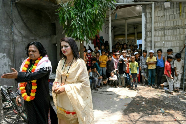 Local children watch as actors peform a scene for a movie in Malegaon