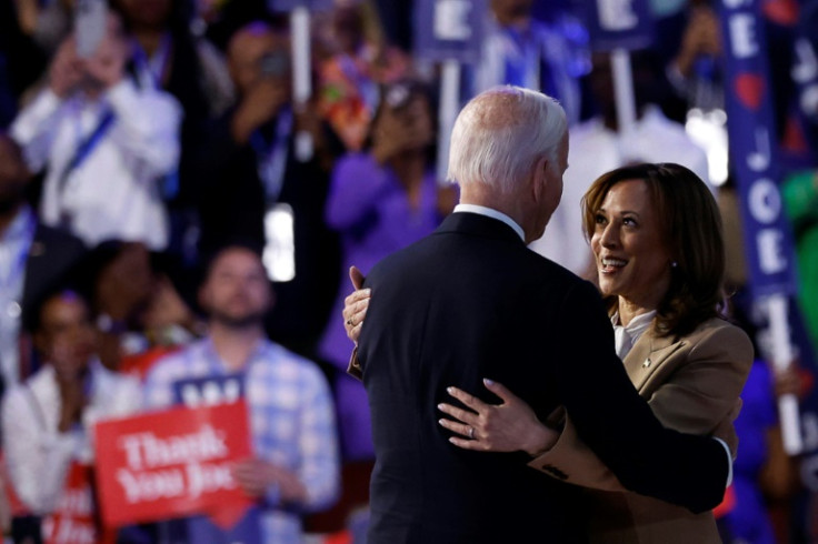 Vice President and Democratic presidential nominee Kamala Harris (R) hugs US President Joe Biden after his speech -- she was deferential to her current boss all night