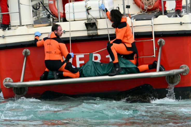 Firefighters brought a body bag ashore but there were no immediate details about who had been found