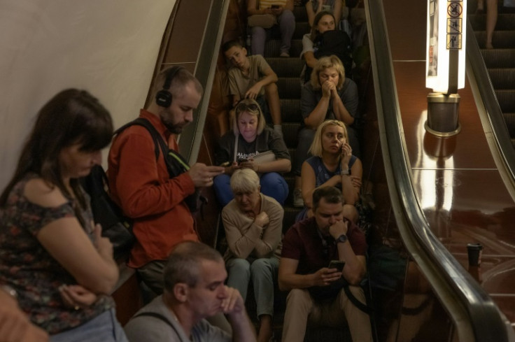 People take shelter in the Teatralna metro station during Monday's attack