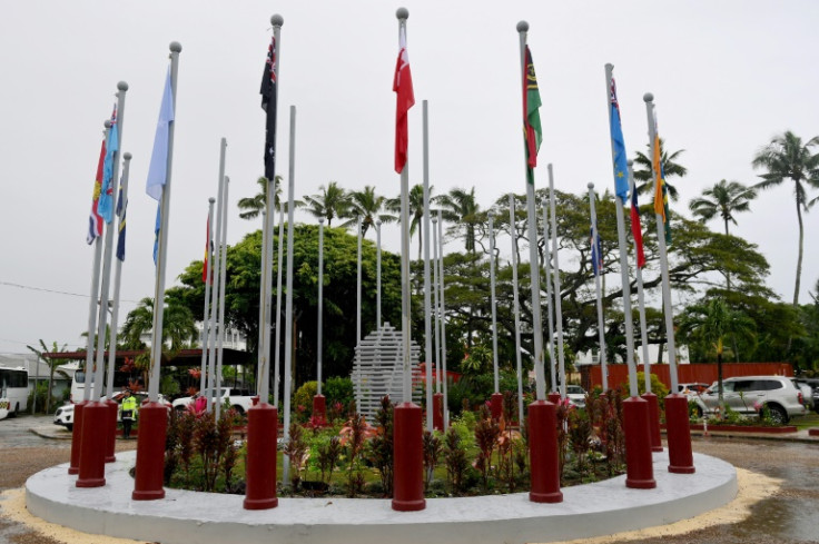 Flags of the Pacific Islands Forum member nations hang outside the convention centre during the group's meeting in Nuku'alofa, Tonga