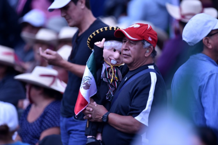 A supporter of Lopez Obrador holds a doll depicting the Mexican president as a mariachi musician in Mexico City's Zocalo Square on September 1, 2024