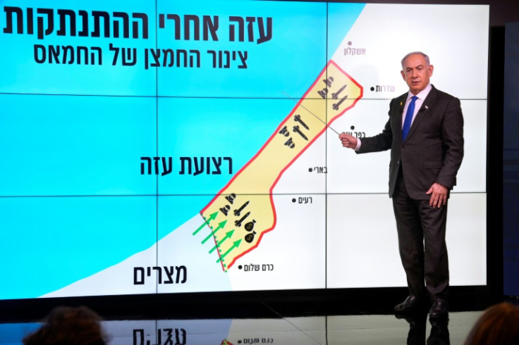 Israeli Prime Minister Benjamin Netanyahu points at a map of the Gaza Strip during a news conference in Jerusalem