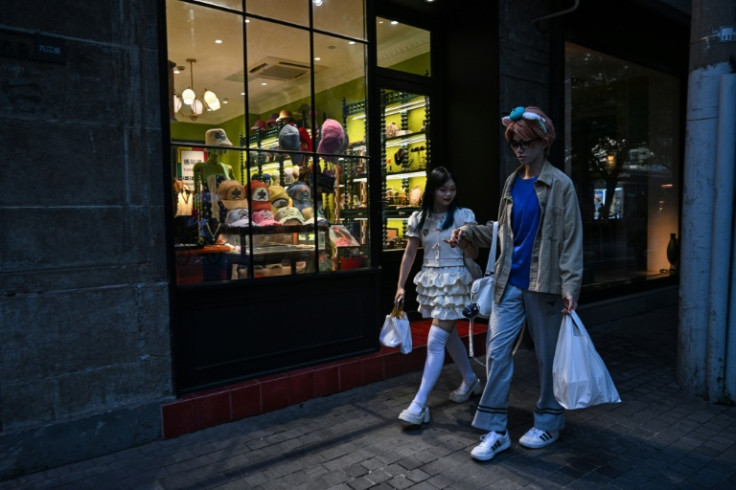 Xu and Feng walking down a street during their 'cos commissioning' date in Shanghai