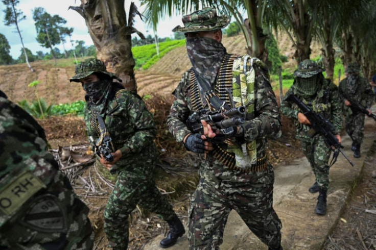 Members of the FARC dissident group Segunda Marquetalia march on a farm in Llorente, Colombia in August 2024